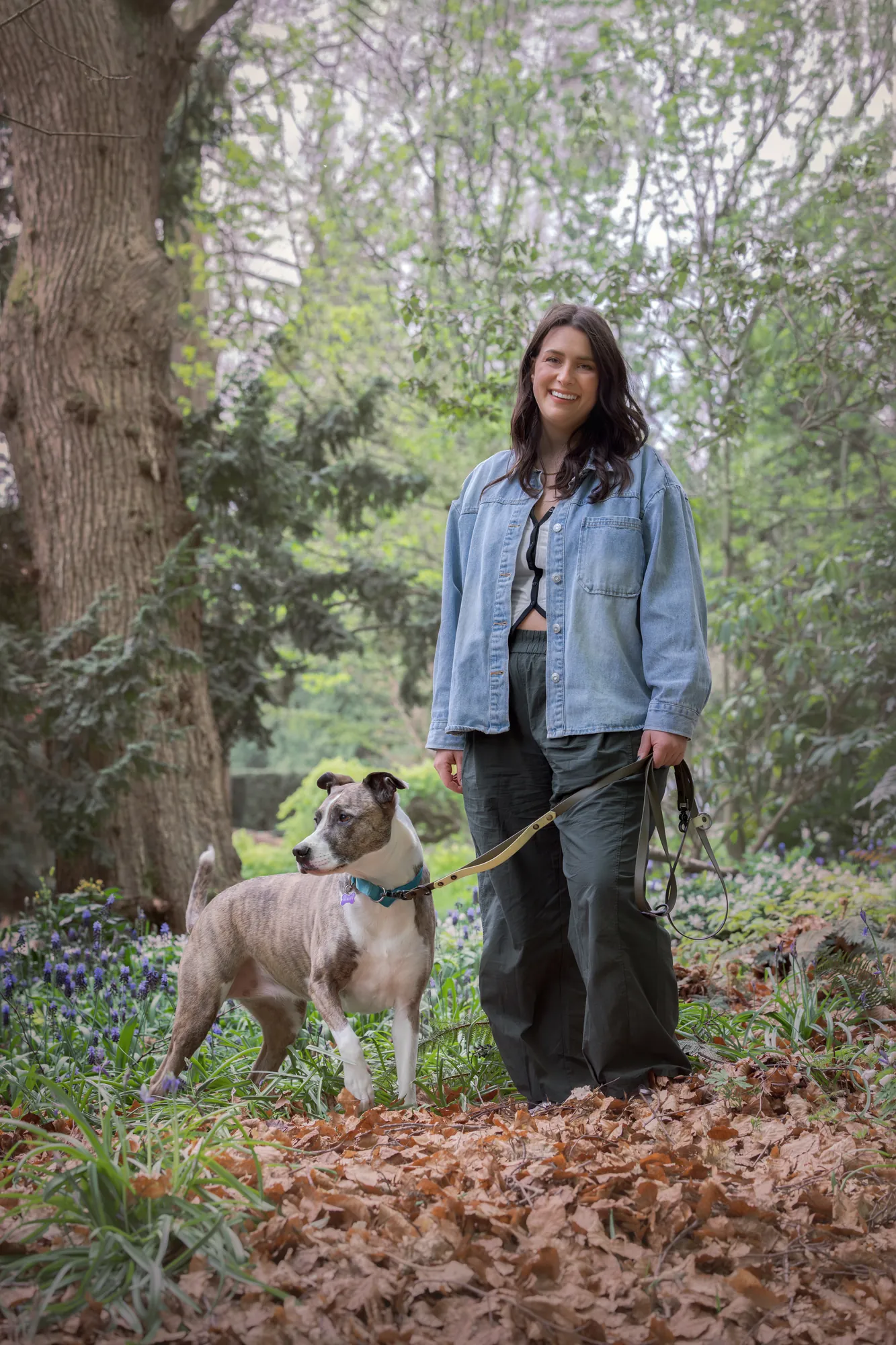 Lea Mestrovic walking her dog on a loose leash through the forest
